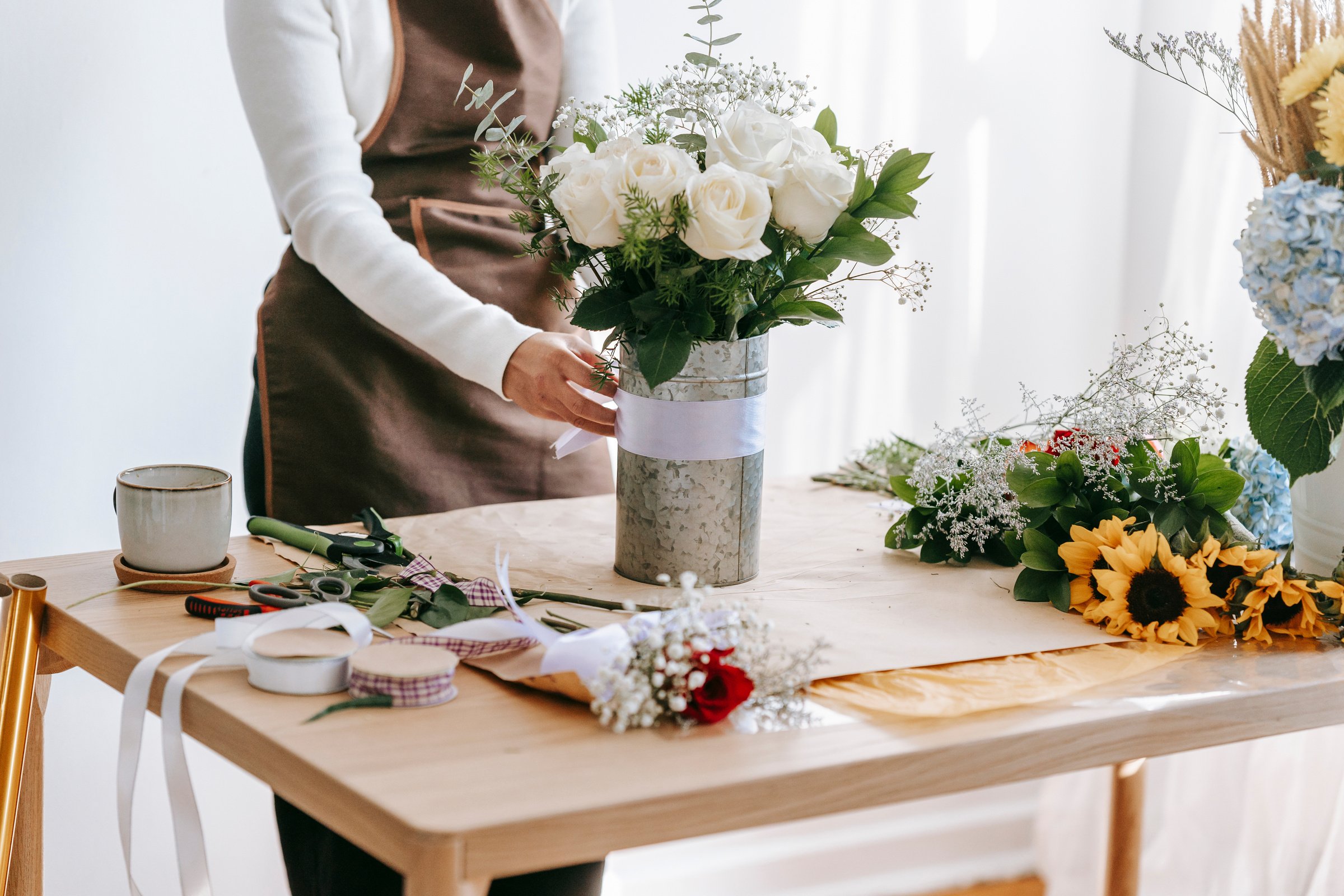 Florist making festive bouquet in light room